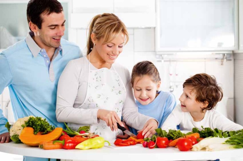 Happy family is preparing a healthy dinner in the kitchen. Mother is cutting vegetables.   [url=http://www.istockphoto.com/search/lightbox/9786778][img]http://img143.imageshack.us/img143/364/familyyv.jpg[/img][/url]